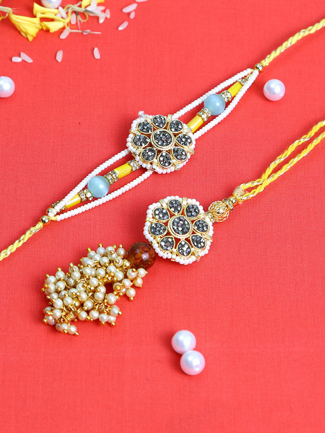 

Aapno Rajasthan Set of 2 Gold-Toned & Red Stones & Pearl Beaded Bhaiya Bhabhi Traditional Rakhi Set