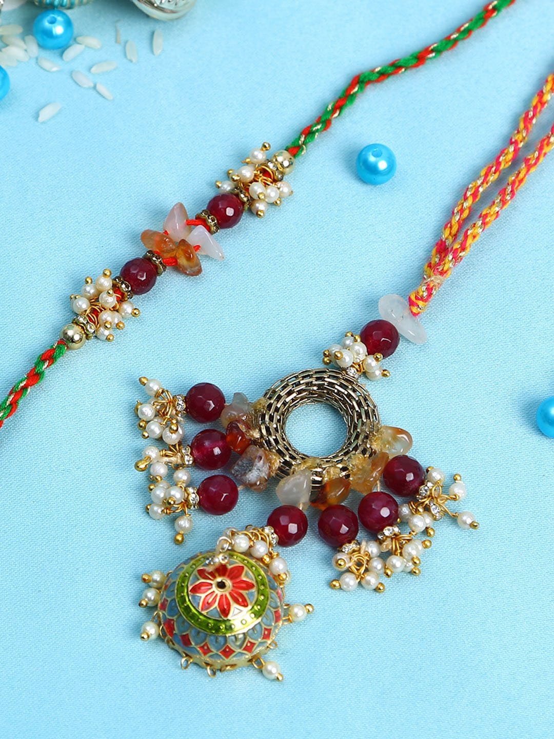 

Aapno Rajasthan Maroon & Gold-Toned Meena Work Bhaiya Bhabhi Rakhi Gift Set