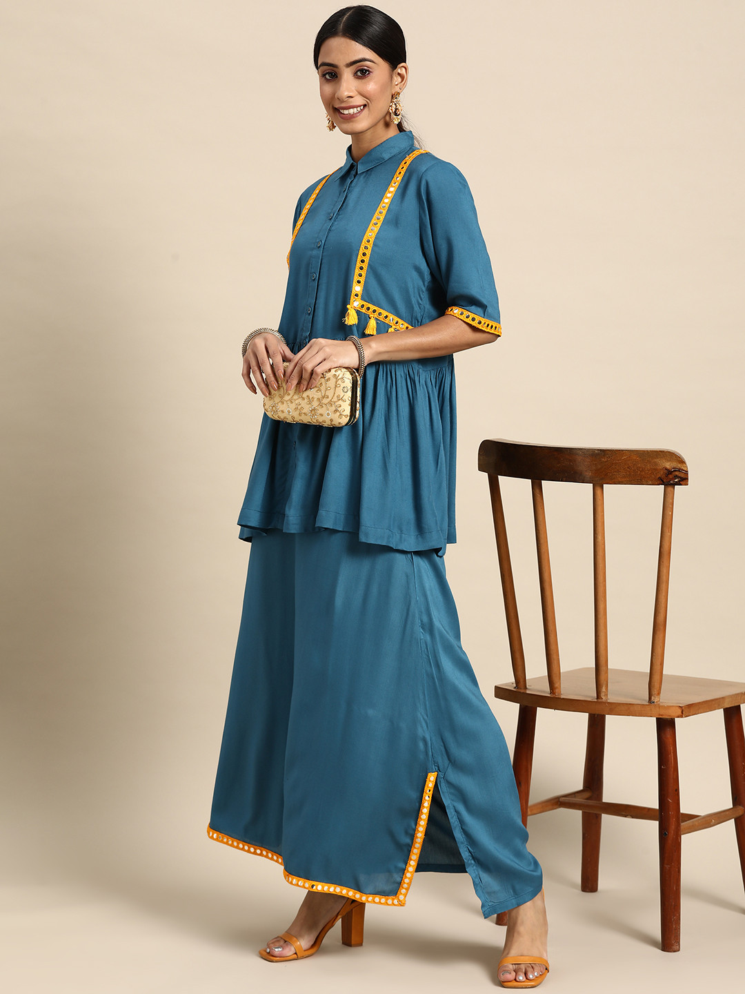 

Sangria Women Teal Blue Solid Mirror Work Kurti with Palazzos