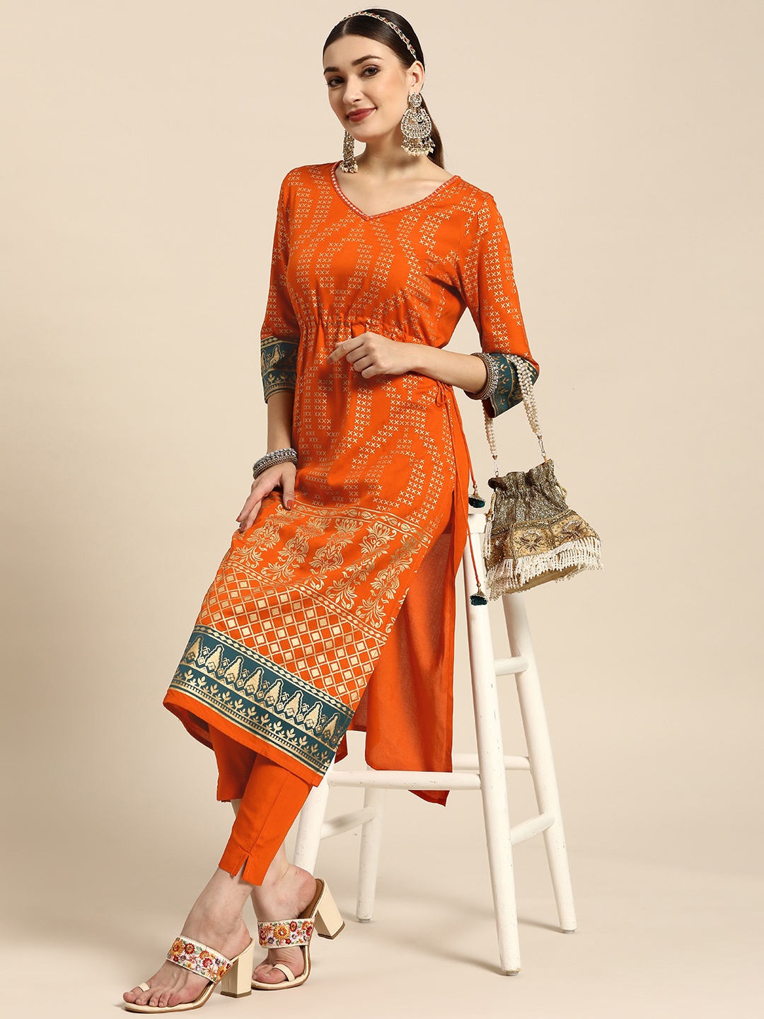 

Sangria Women Orange Ethnic Motifs Printed Mirror Work Tassel Detail Kurta with Trousers