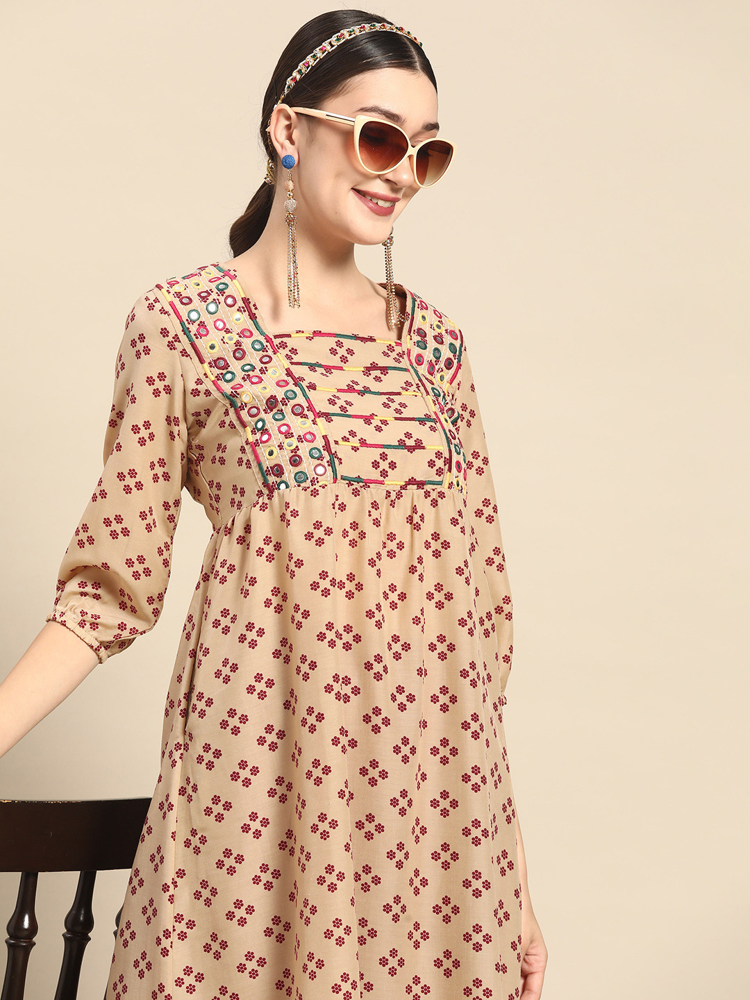 

Sangria Women Beige & Red Ethnic Motifs Printed Empire Mirror Work Kurta with Trousers