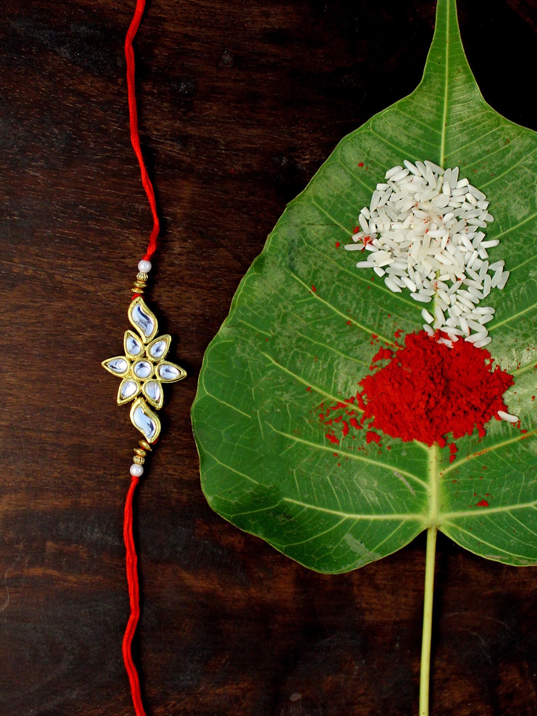 

KARATCART Gold-Plated Red Kundan Rakhi with Roli & Chawal