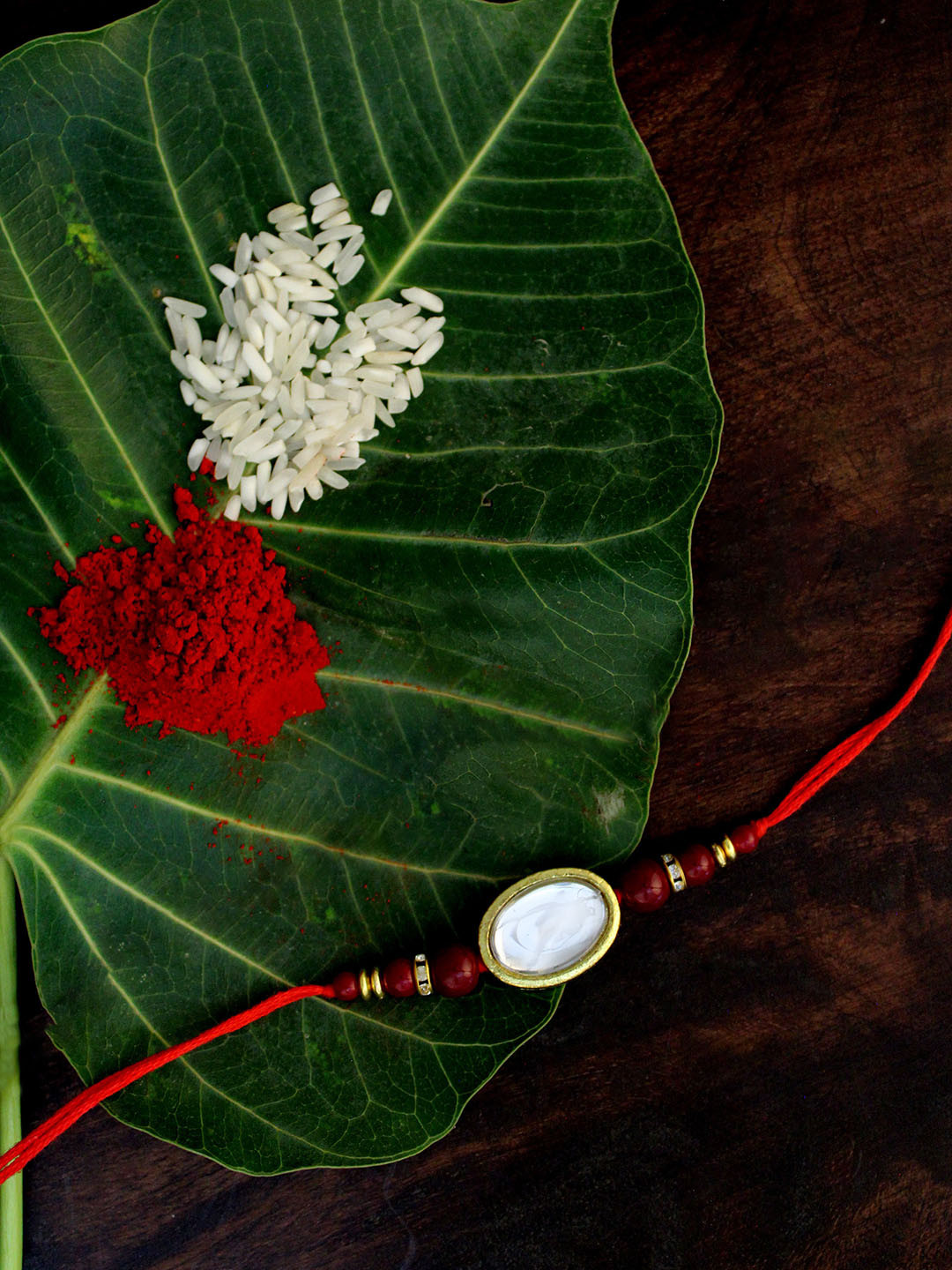 

KARATCART Men Gold-Toned White & Red Stone-Studded & Beaded Rakhi