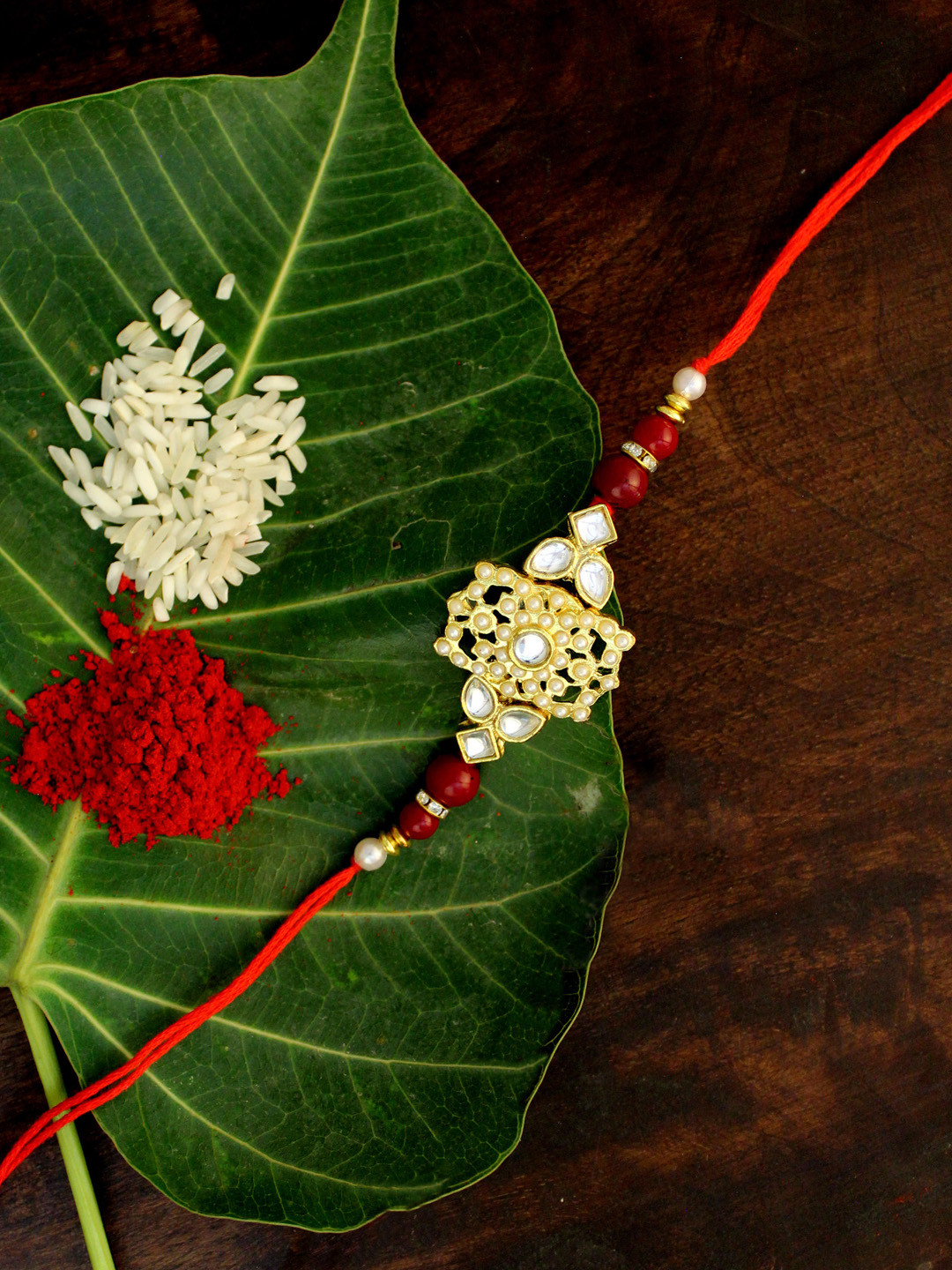 

KARATCART Men Gold-Toned White & Red Stone-Studded & Beaded Rakhi