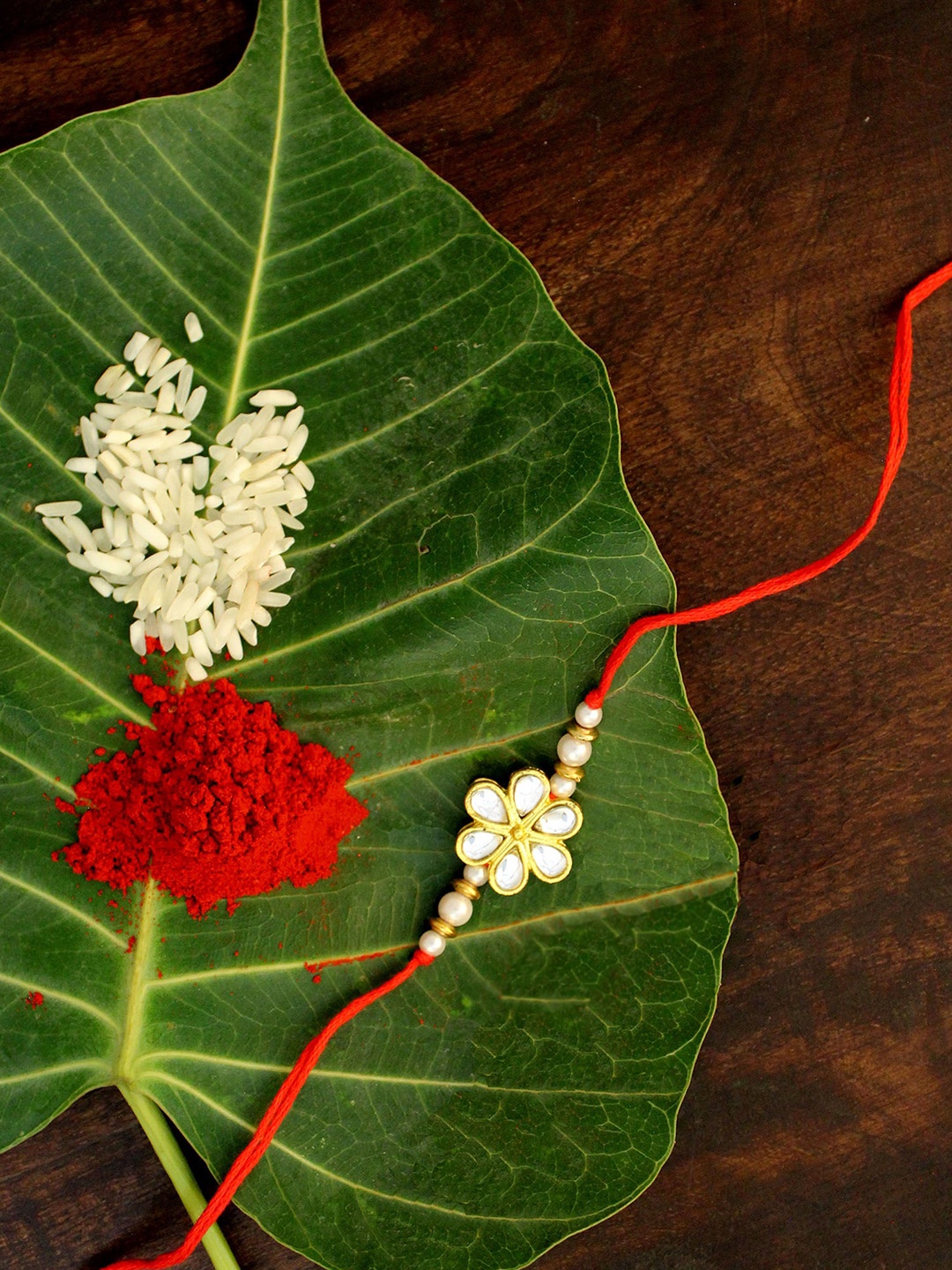 

KARATCART Men Gold-Plated White Kundan-Studded & Beaded Rakhi with roli and chawal