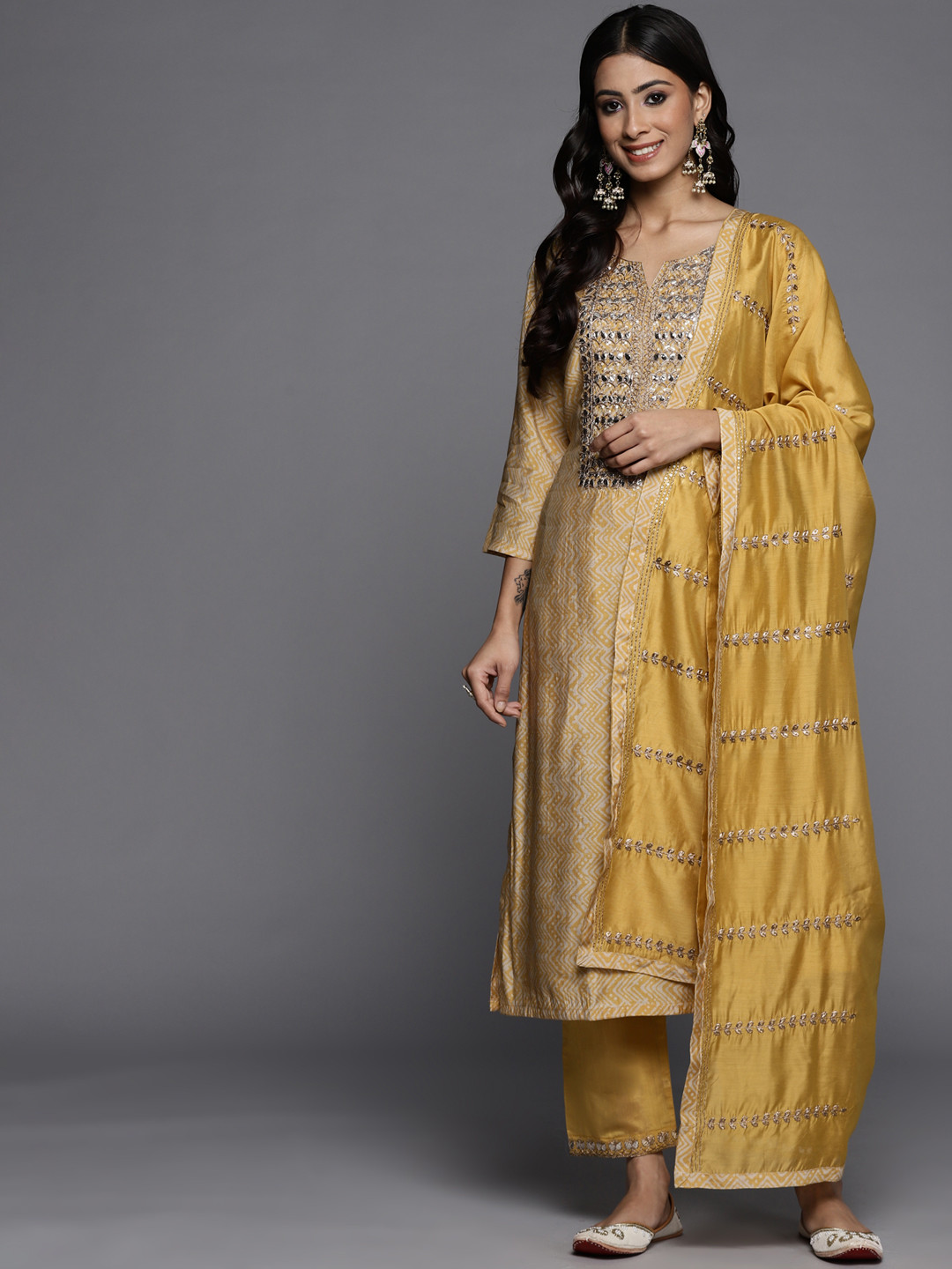 

Varanga Women Mustard Yellow Printed Mirror Work Kurta with Trousers & Dupatta