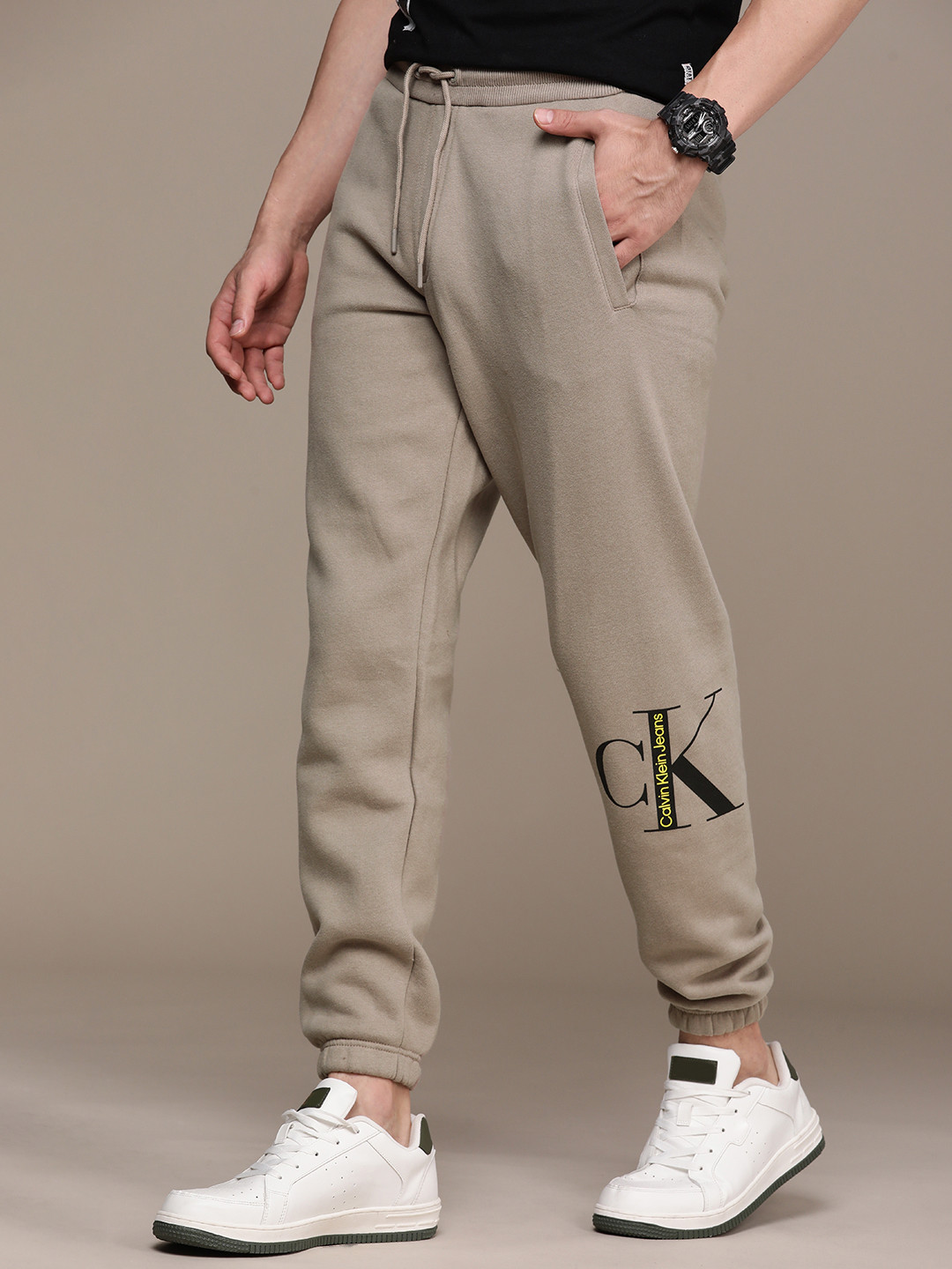 

Calvin Klein Jeans Men Beige Brand Logo Printed Pure Cotton Joggers
