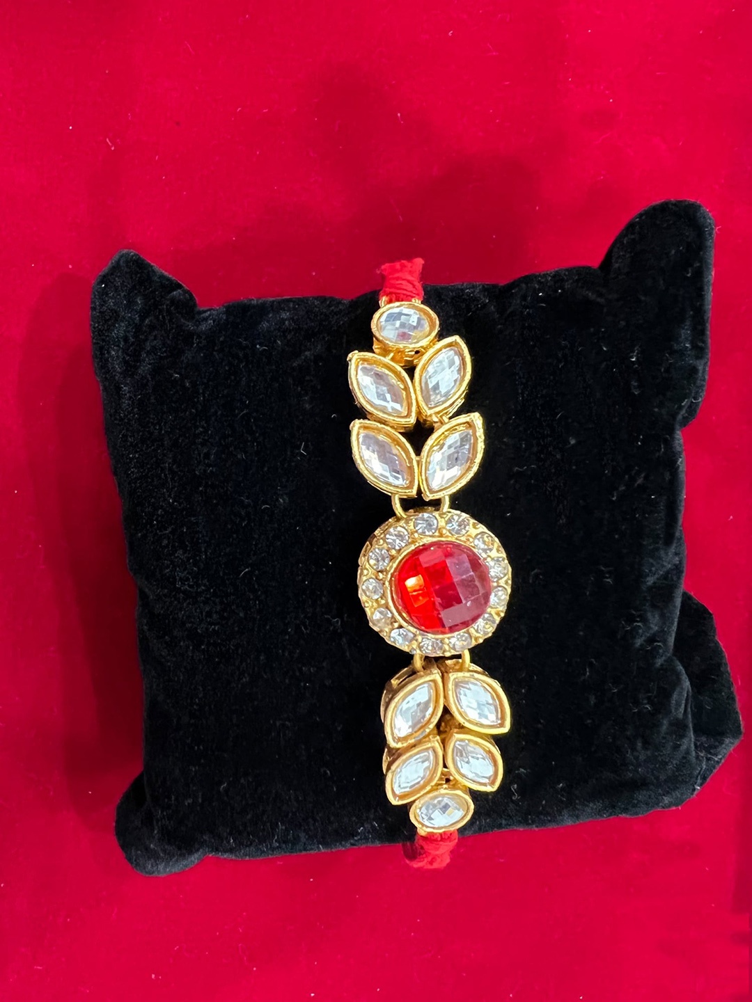 

Vembley Gold-Toned & Red Kundan Stone Rakhi