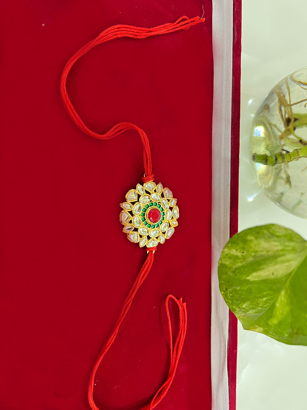 

Vembley Gold-Toned & Red Kundan Rakhi