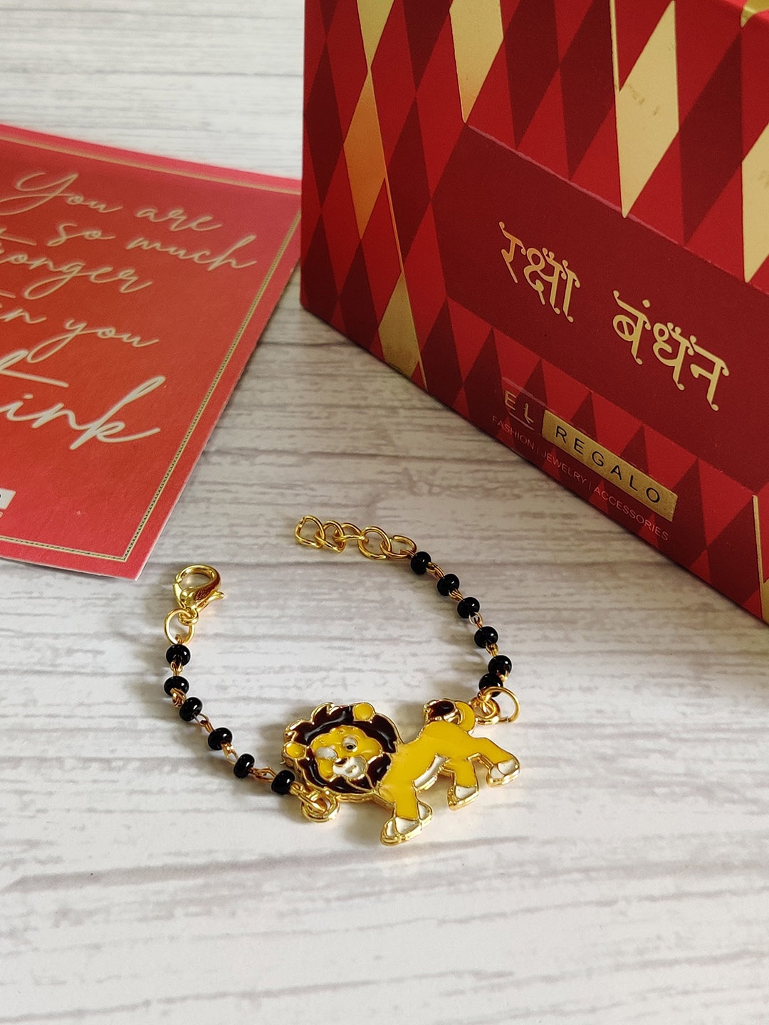 

EL REGALO Baby Yellow Nazaria Rakhi Combo with Greeting Card Roli Chawal Shagun