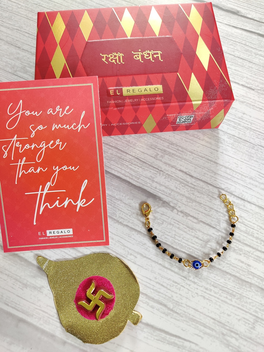 

EL REGALO Baby Gold-Toned Nazaria Rakhi Combo with Greeting Card Roli Chawal Shagun