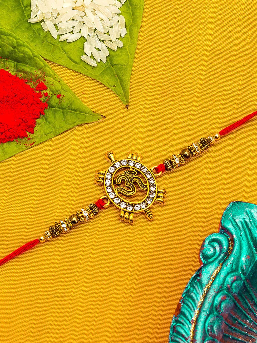 

Aadita Men Gold Toned & White Stone Studded Handmade String Rakhi