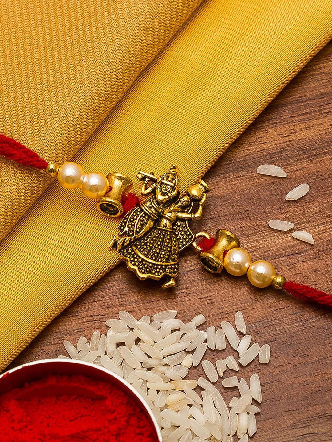 

aadita Gold Toned & Red Studded Thread Rakhi