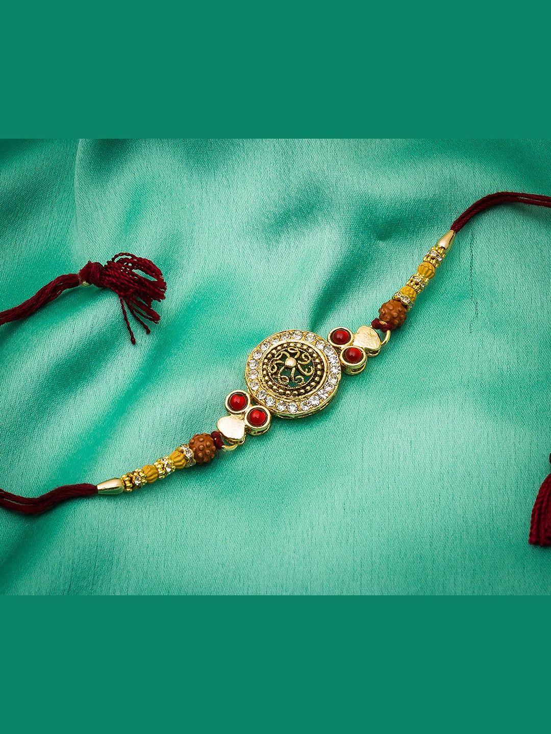 

Aadita Men Gold Toned & Red AD Stone Studded Rakhi