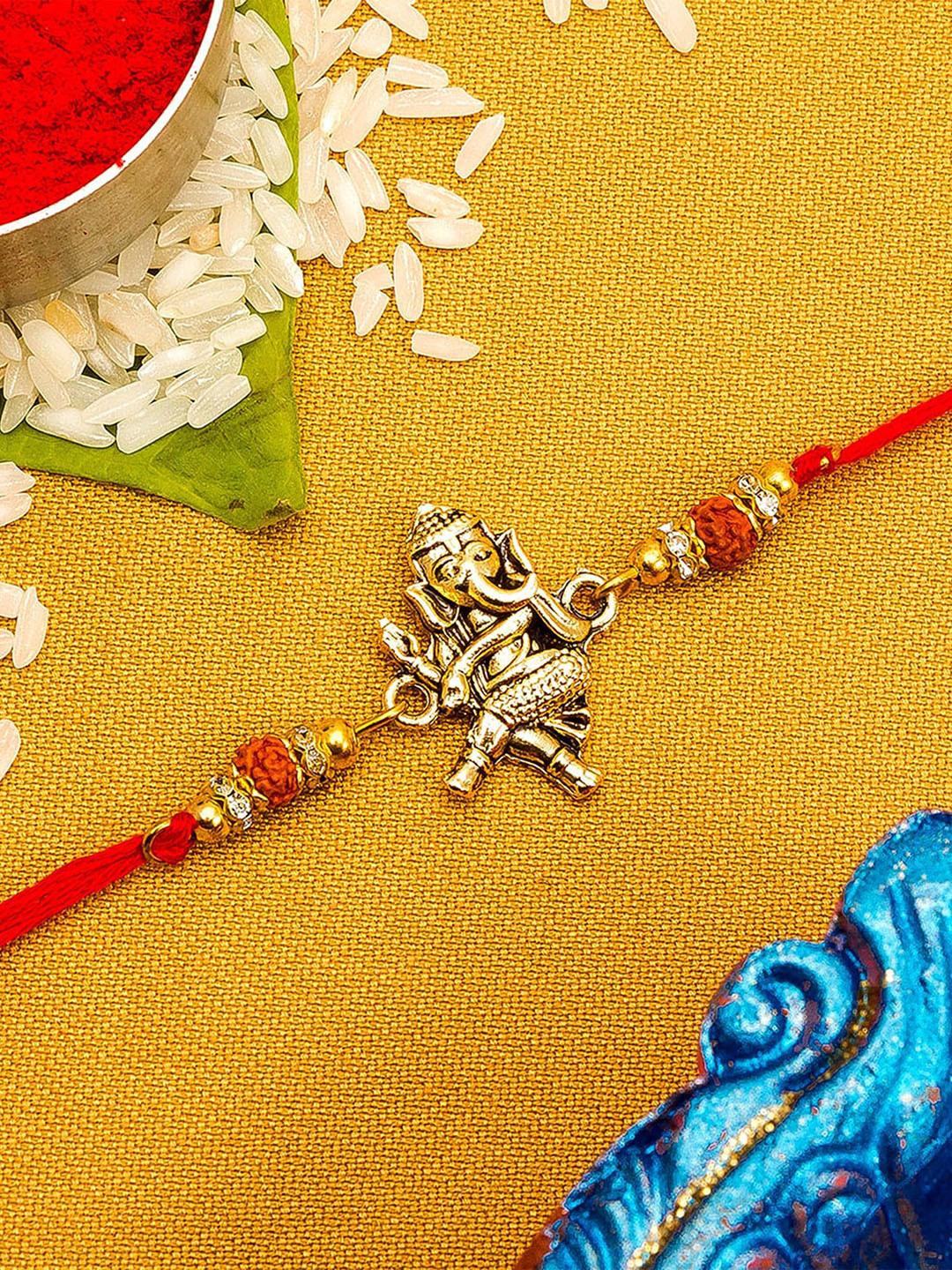 

aadita Gold Toned Ganesha Idol Stone Studded Rakhi