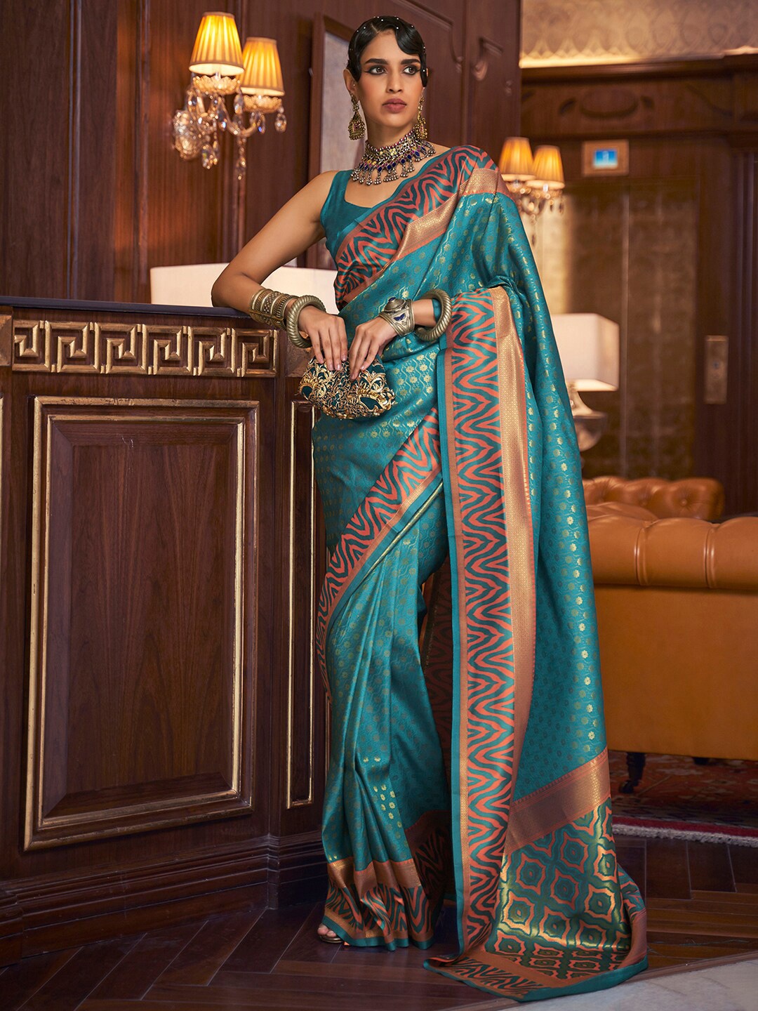 

Mitera Turquoise Blue & Gold-Toned Ethnic Motifs Silk Blend Banarasi Saree