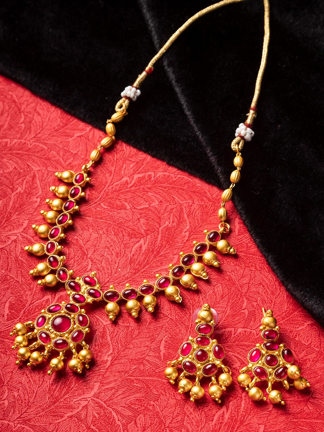 

StileAdda Gold-Plated Red Stone Studded & Beaded Jewellery Set