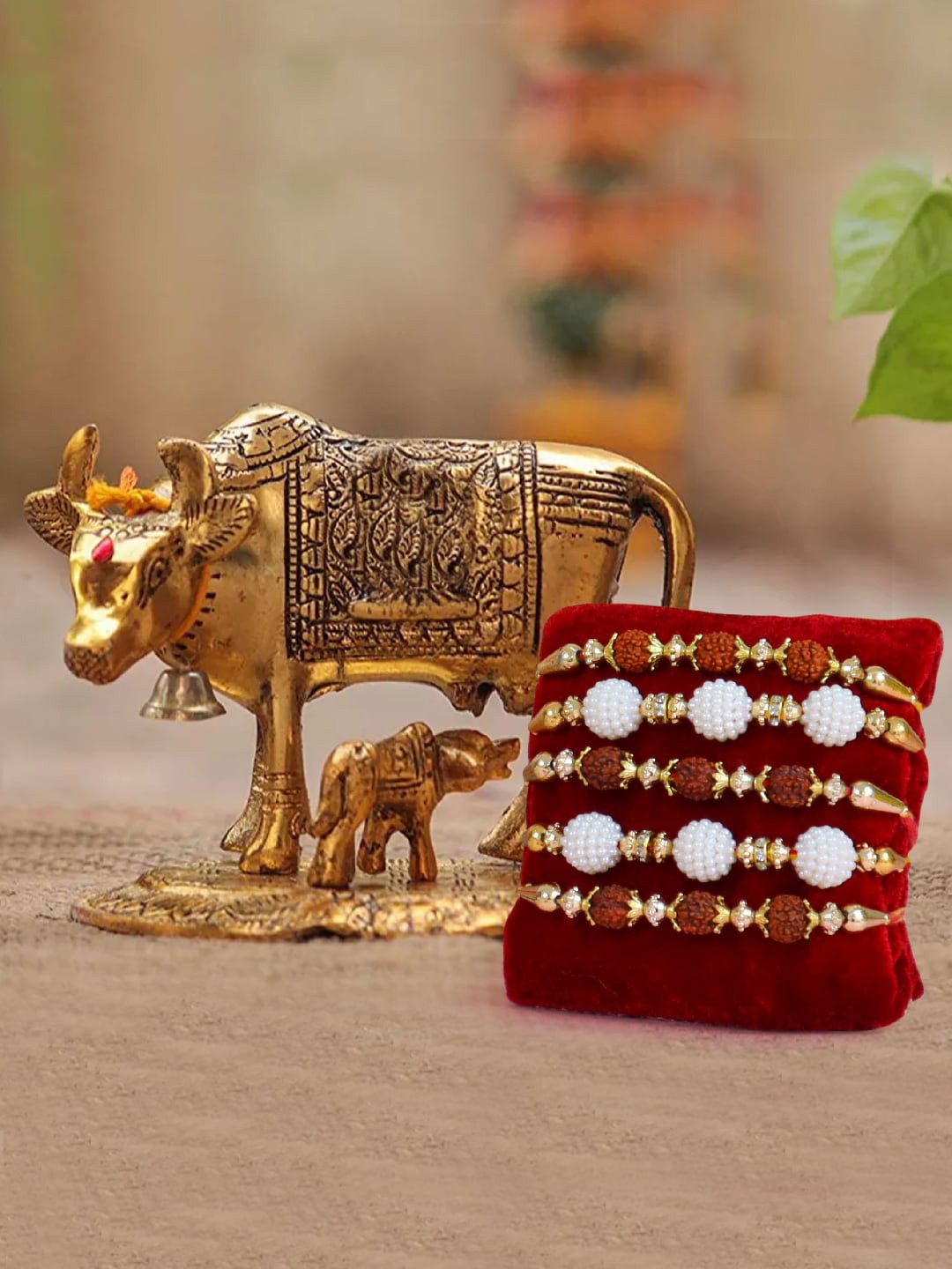 

TIED RIBBONS Red & White Set Of 5 Rakhi & Cow Idol With Calf Idol