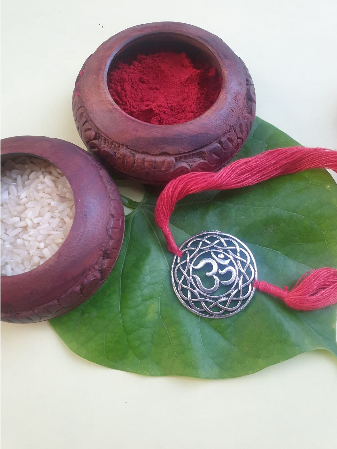 

FIROZA Women Silver-Toned & Red Om Rakhi