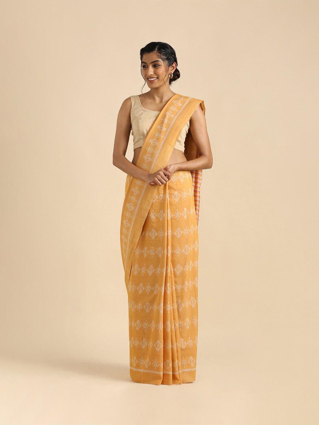 

Taneira Beige & Off White Ethnic Motifs Pure Cotton Ikat Saree