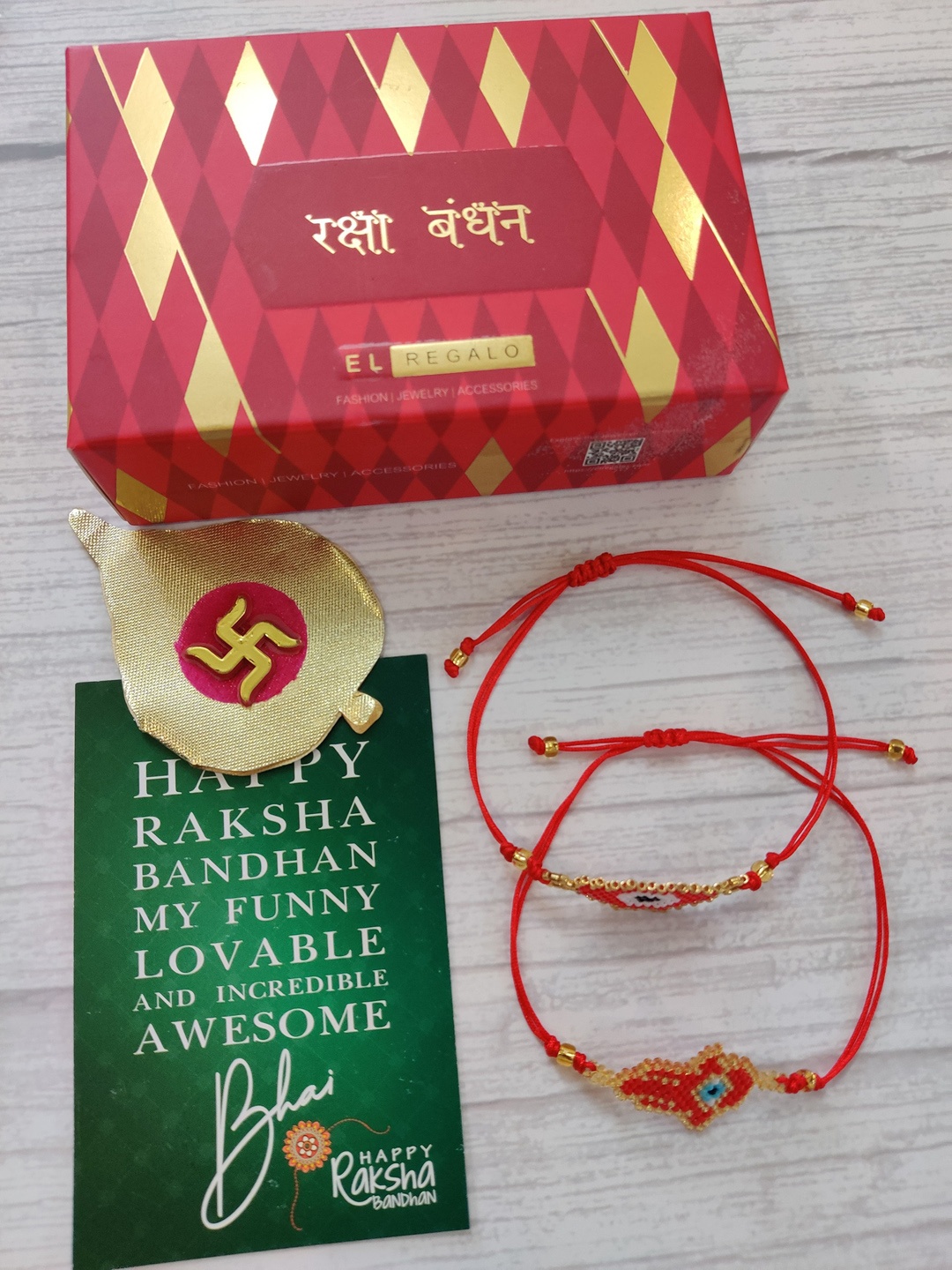 

EL REGALO Set Of 2 Red Evil-Eye Hamsa Rakhi With Roli Chawal & Greeting Card