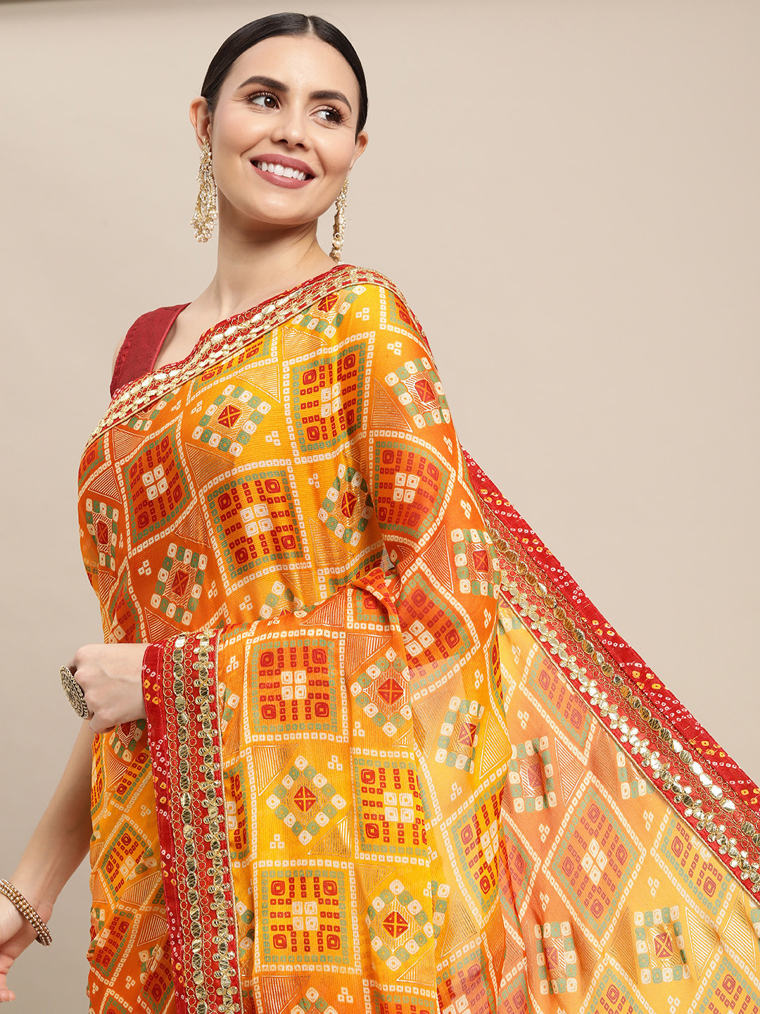 

VASTRANAND Yellow & Red Mirror Work Bandhani Saree