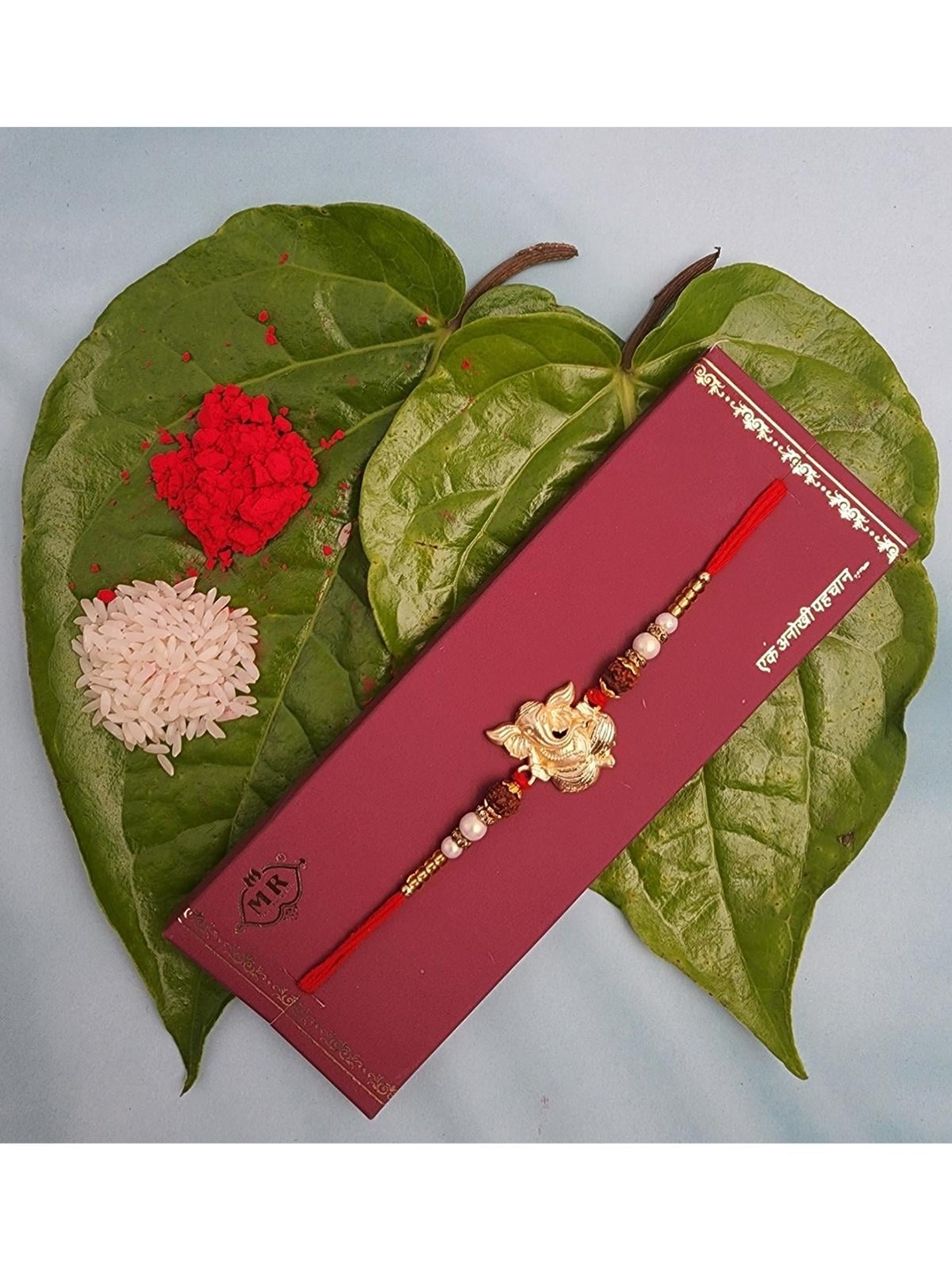 

YOUSTYLO Red & Gold-Toned Lord Ganesha Rakhi With Card & Roli Chawal