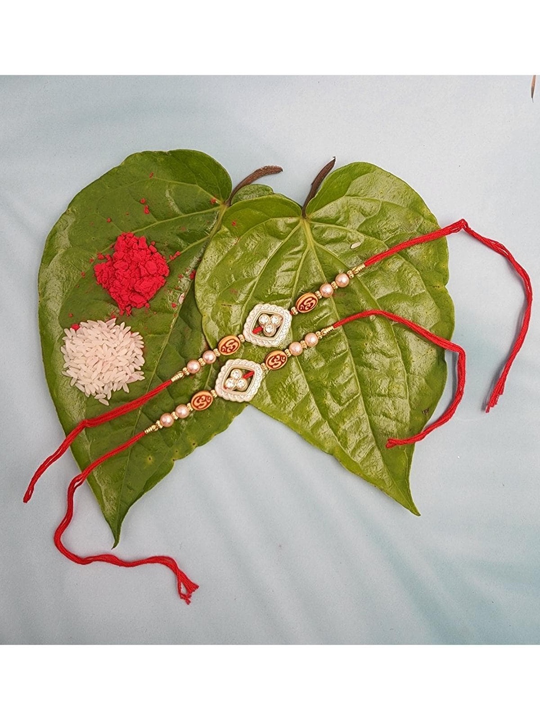 

YOUSTYLO Set of 2 Red & White Om Stone Studded Rakhi with Roli Chawal & Greeting Card