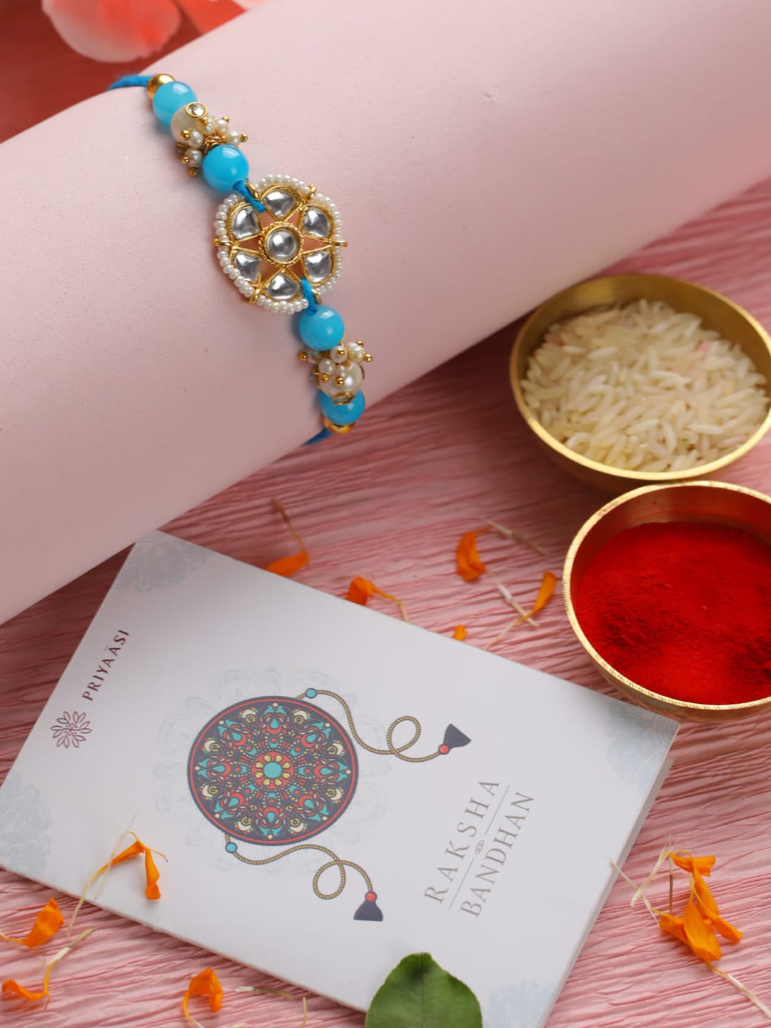 

Priyaasi Blue & White Kundan-Studded Floral Rakhi With Roli & Chawal