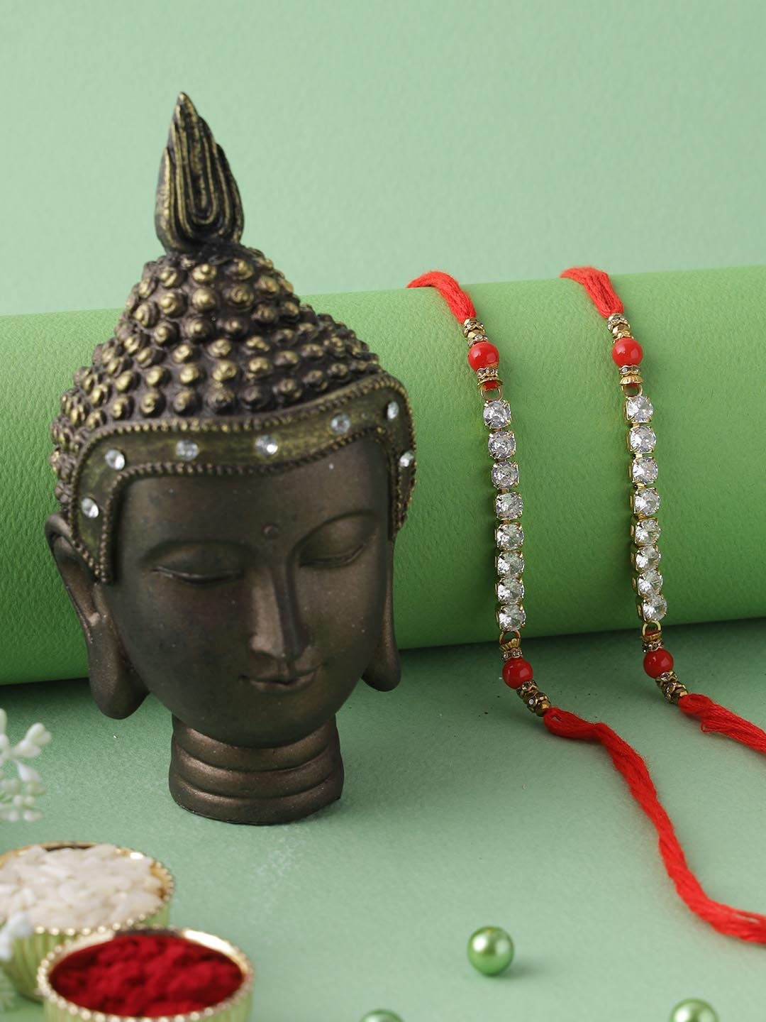 

Aapno Rajasthan Red & White Set of 2 Rakhi with Buddha Idol Gift Set