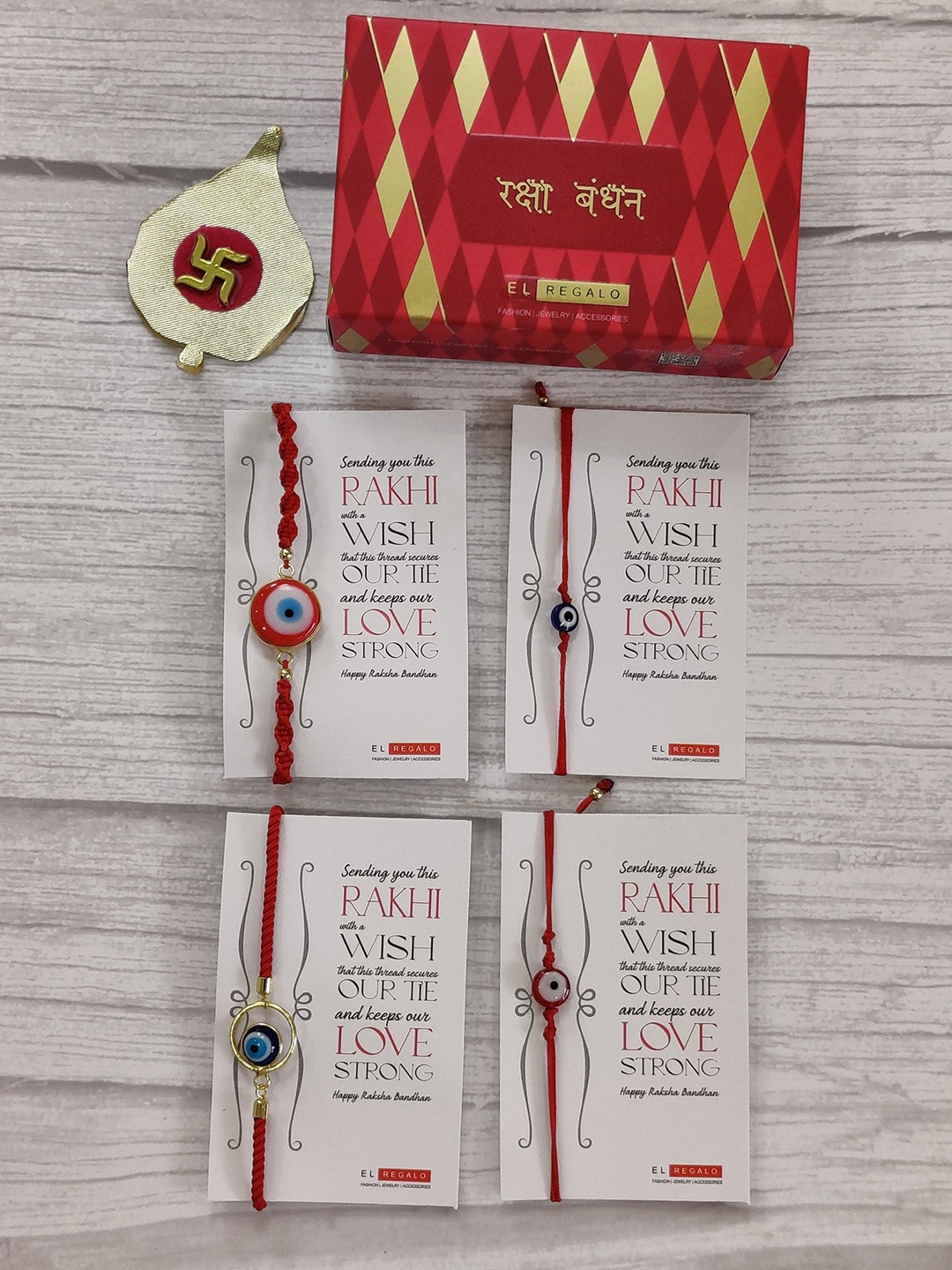 

EL REGALO Set Of 4 Red Evil Eye Wraparound Rakhi With Roli Chawal & Raksha Bandhan Greeting Card