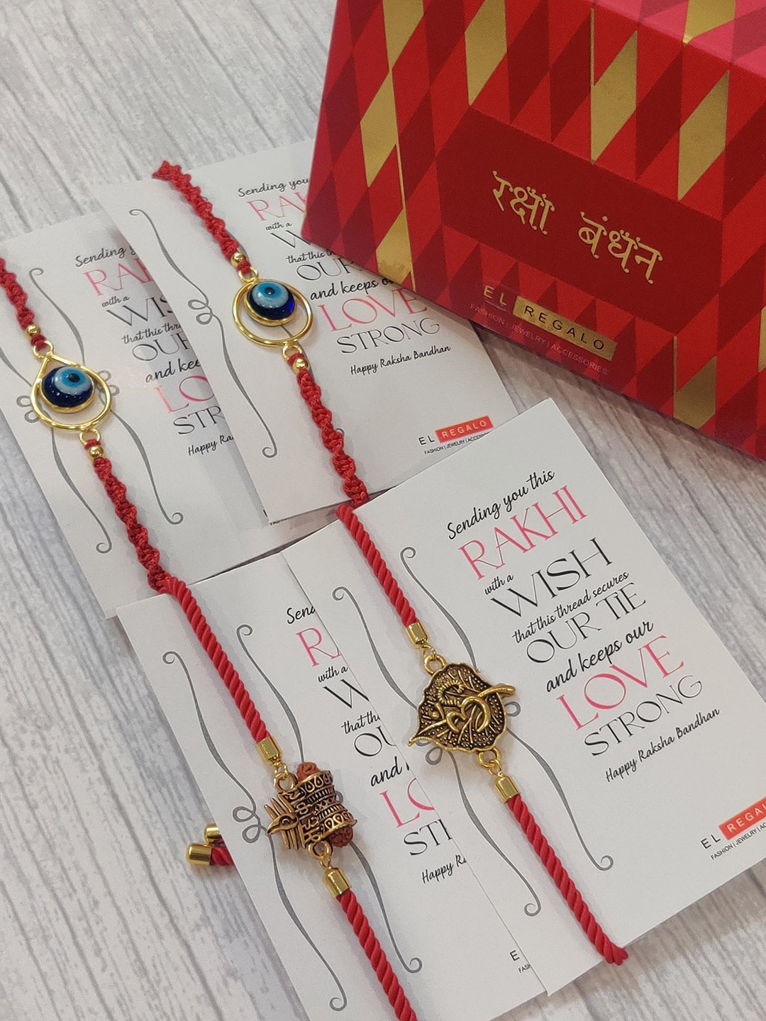 

EL REGALO Set Of 4 Red & Gold Coloured Rakhi With Roli Chawal & Greeting Card