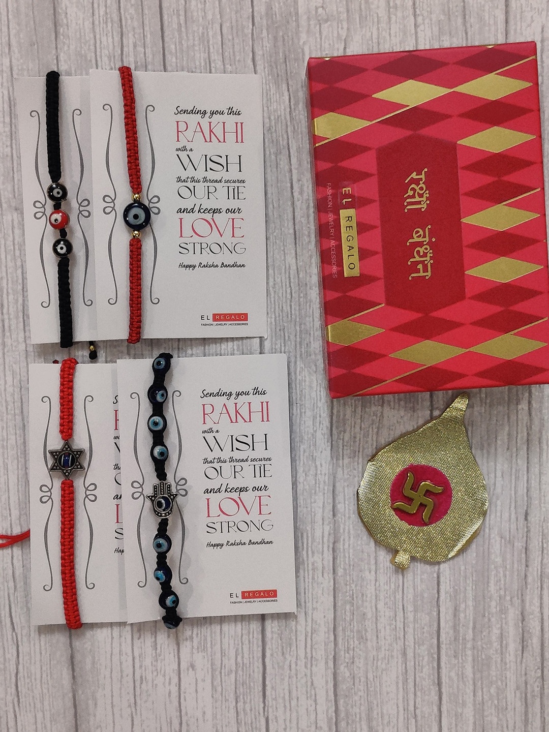 

EL REGALO Set Of 4 Red & Blue Evil Eye Wrap Around Rakhi With Roli Chawal & Raksha Bandhan Greeting Card