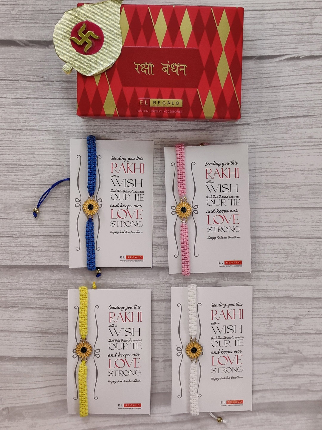 

EL REGALO Set Of 4 Blue & Yellow Floral Wrap Around Rakhi With Roli Chawal & Greeting Card