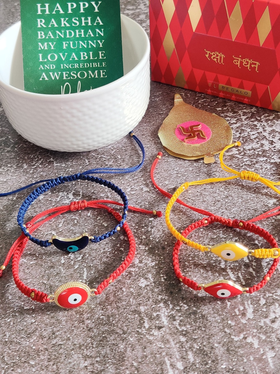 

EL REGALO Red & Yellow Set Of 4 Evil Eye Rakhi With Roli Chawal & Greeting Card