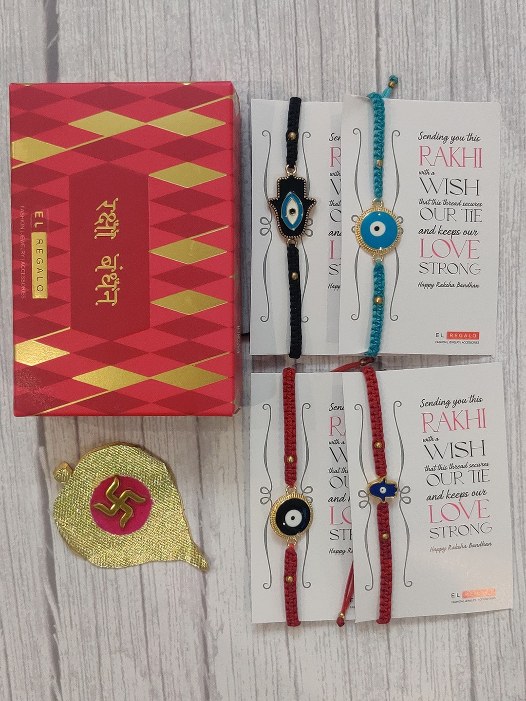 

EL REGALO Set Of 4 Red & Blue Evil Eye Wrap Around Rakhi With Roli Chawal & Raksha Bandhan Greeting Card