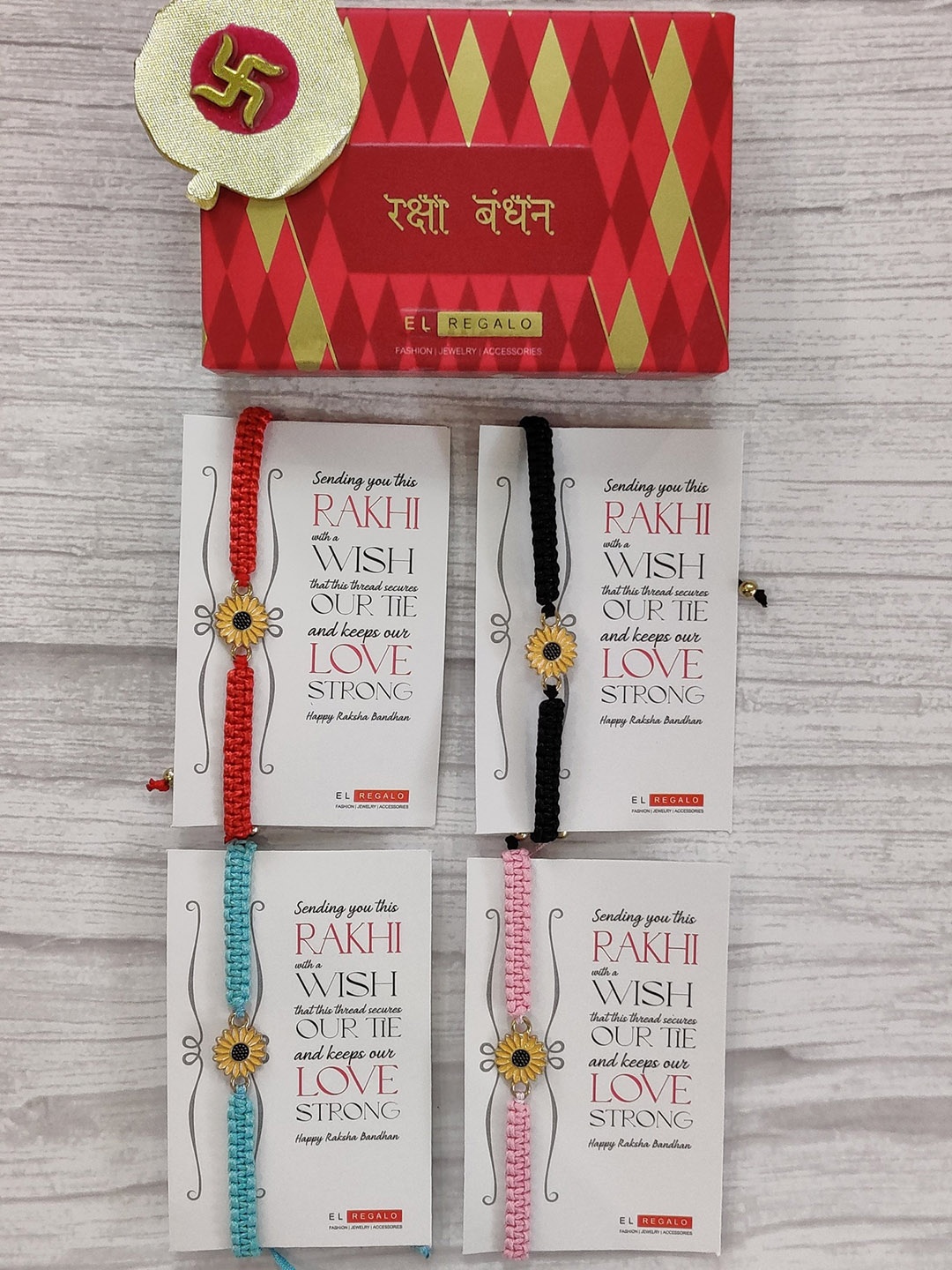 

EL REGALO Set Of 4 Red, Black & Blue Floral Wrap Around Rakhi With Roli Chawal & Raksha Bandhan Greeting Card