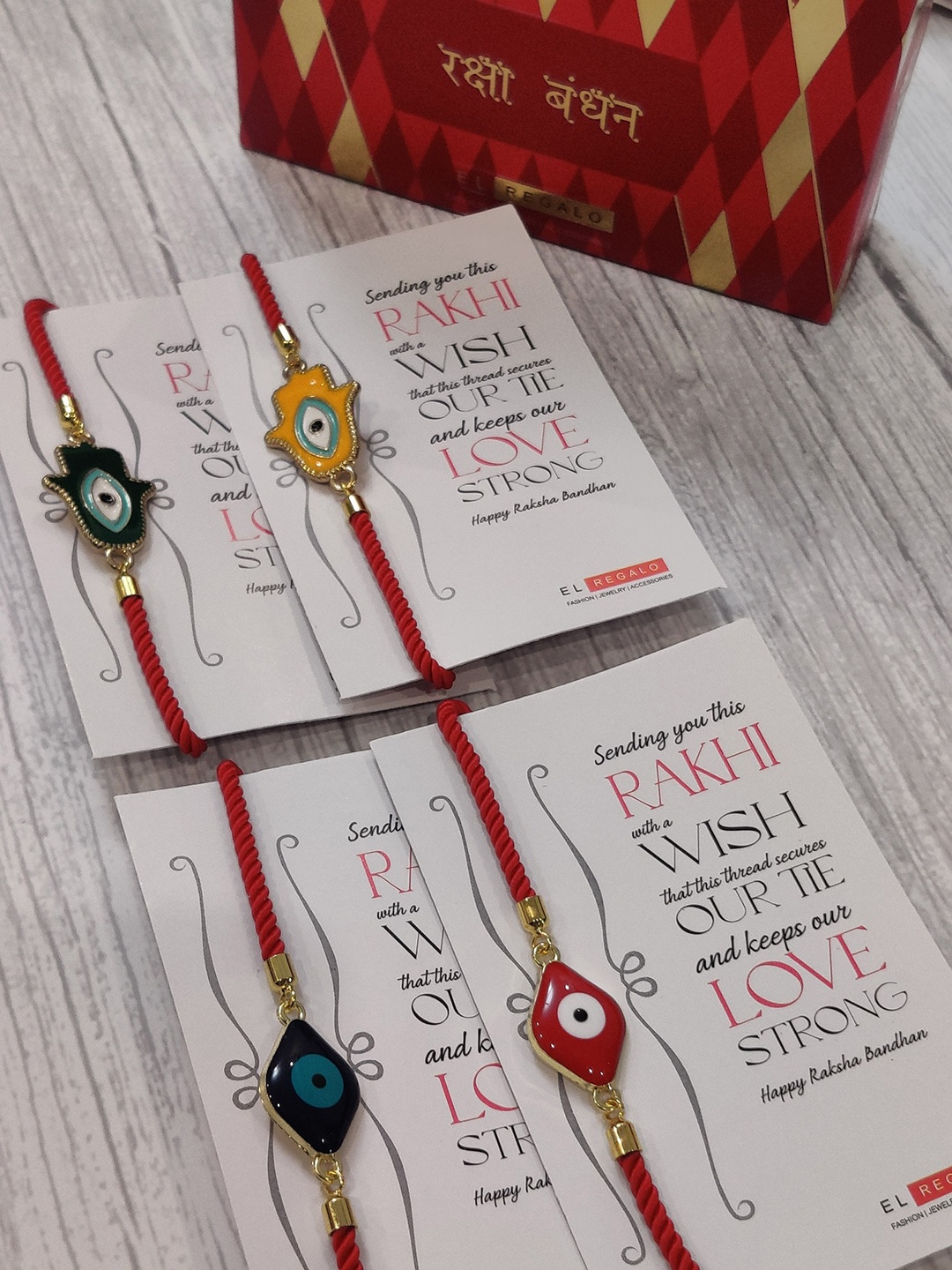 

EL REGALO Set Of 4 Evil Eye Wrap Around Rakhi With Roli Chawal & Raksha Bandhan Greeting Card, Gold