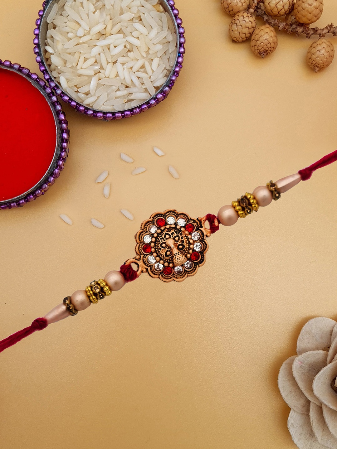 

STYBUZZ Rose Gold-Toned Peacock Rakhi With Roli Chawal