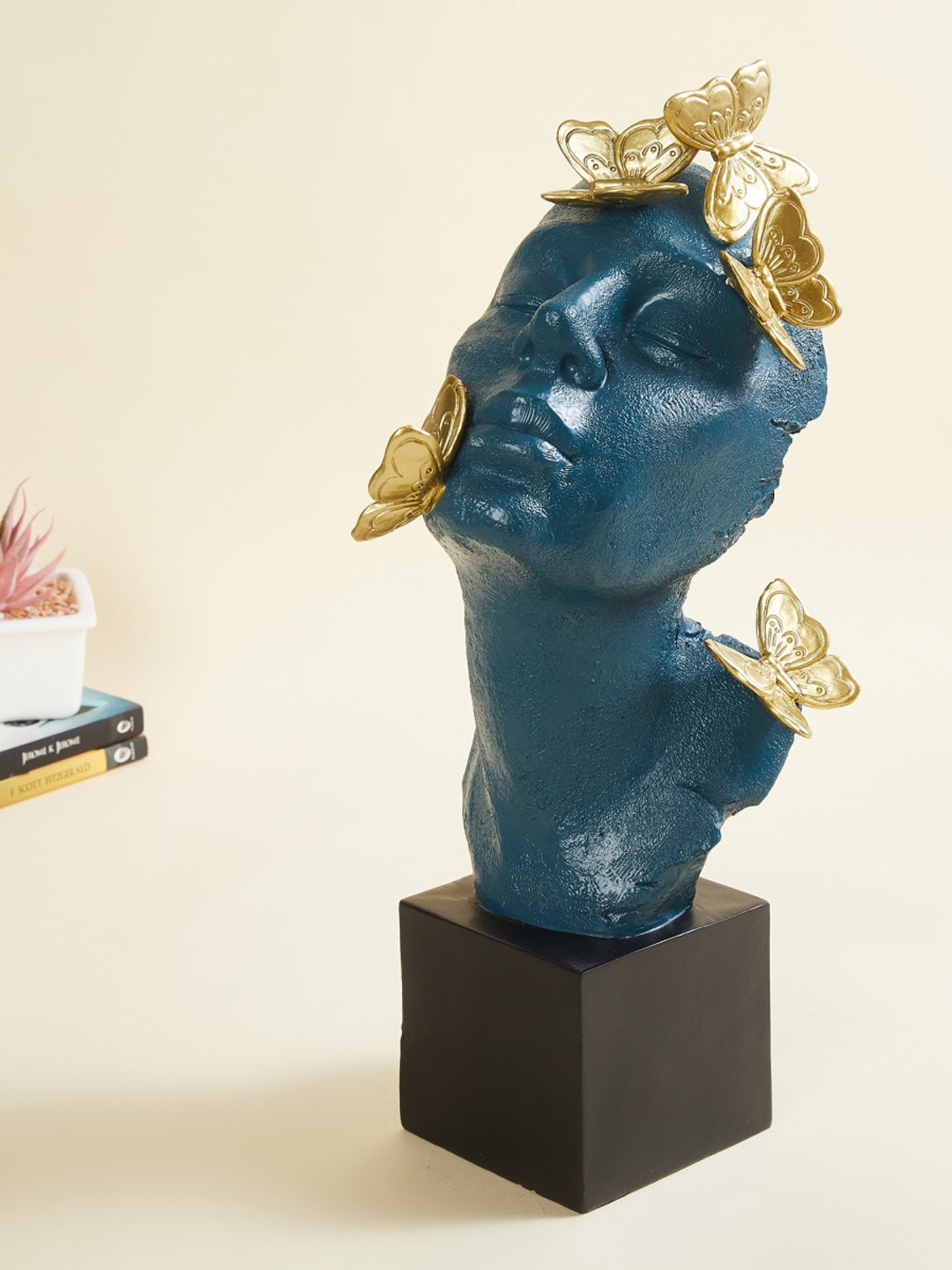 

Home Centre Teal-Blue & Gold-Toned Textured Face with Butterfly Figurine Showpieces