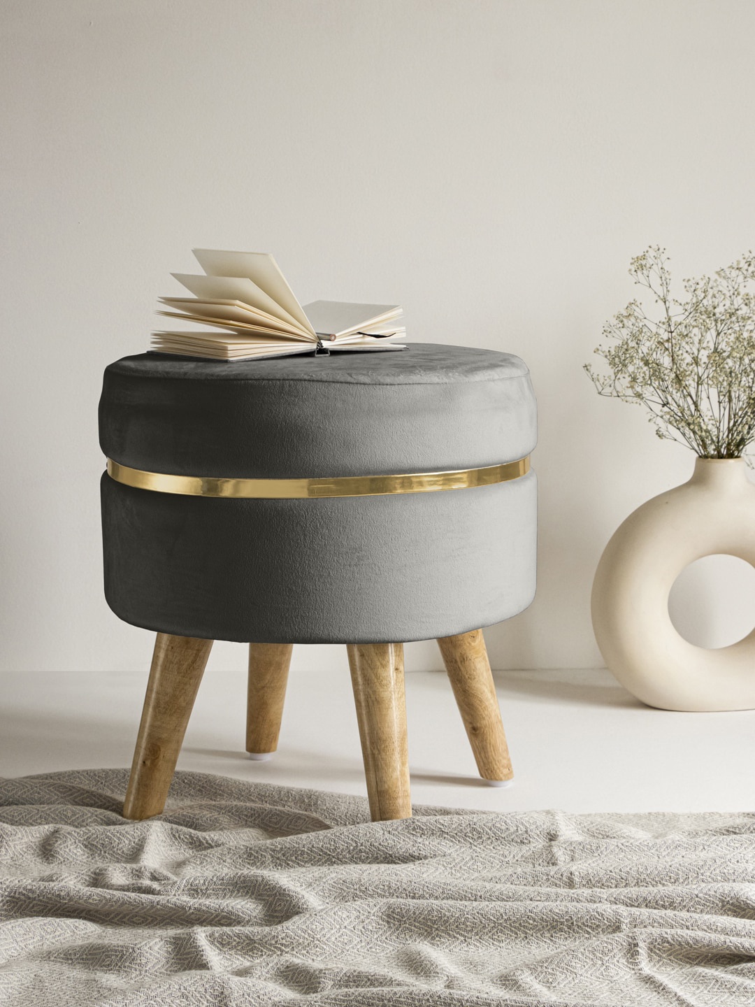 

Clasiko Grey Solid Ottoman With Golden Ring & Wood Legs