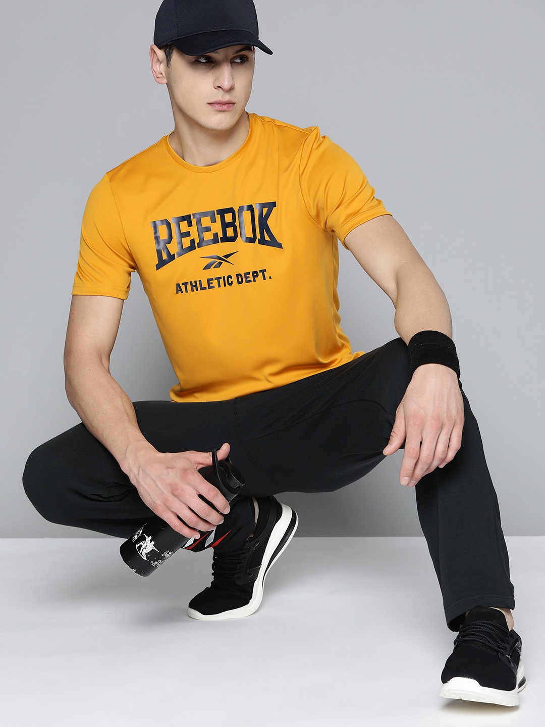 

Reebok Men Brand Logo Printed Fitness WOR Speedwick T-shirt, Mustard