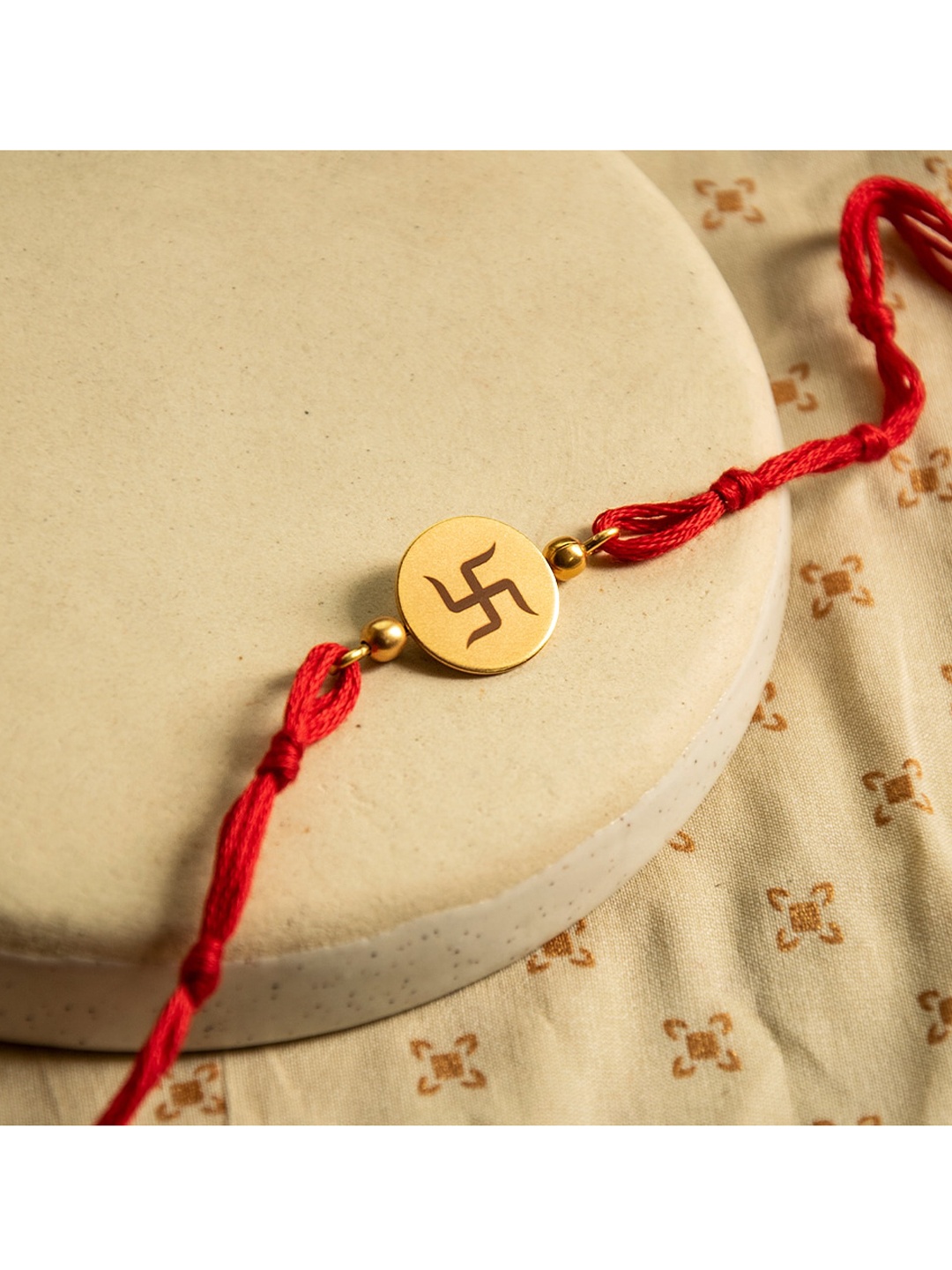 

Suhani Pittie Men Red & Gold-Plated Swastik Rakhi