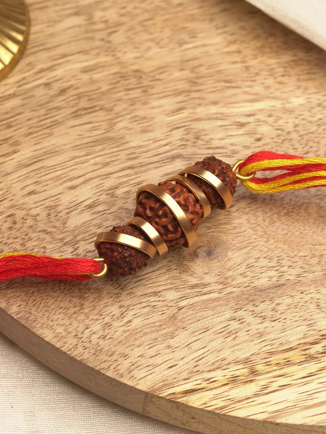 

Suhani Pittie 22K Gold Plated Red Rudraksh Thread Rakhi