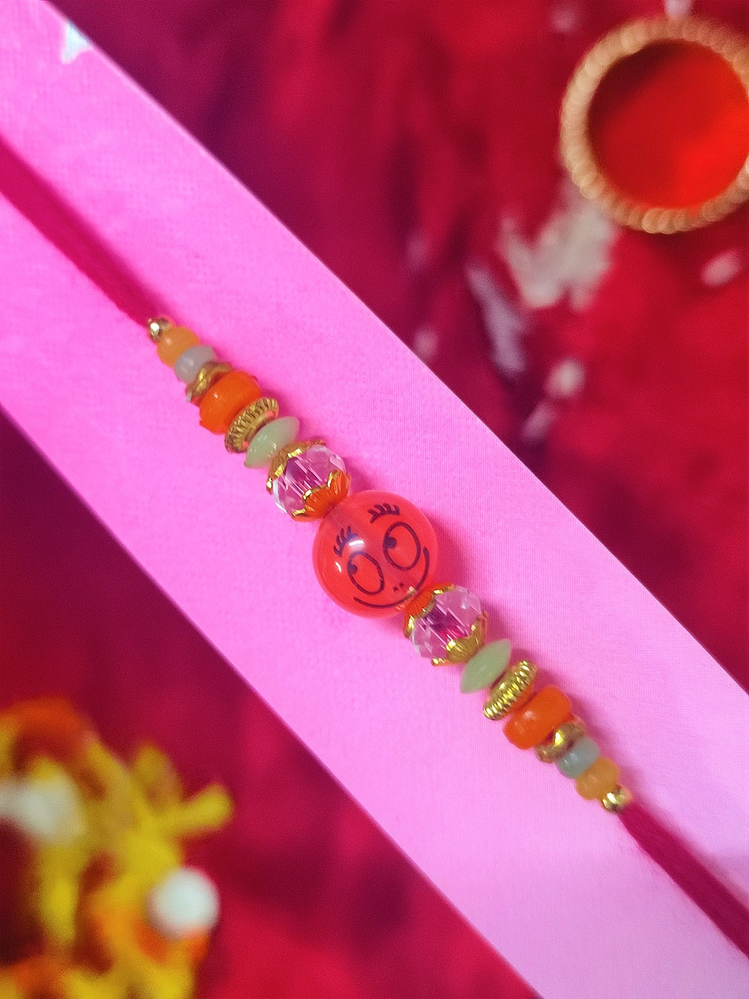 

CRAYTON Red Pearl Smiley Thread Rakhi