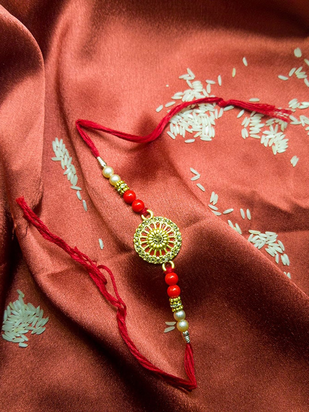 

CRAYTON Gold-Colored Red Minakari-Studded Rakhi