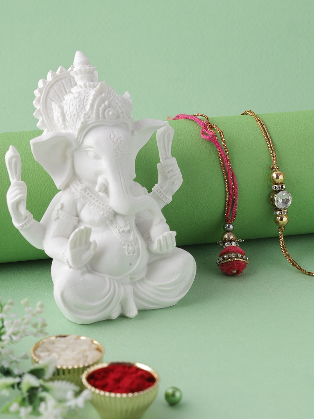 

Aapno Rajasthan White, Red & Gold Coloured Ganesha Idol With Bhaiya Bhabhi Rakhi With Roli & Chawal