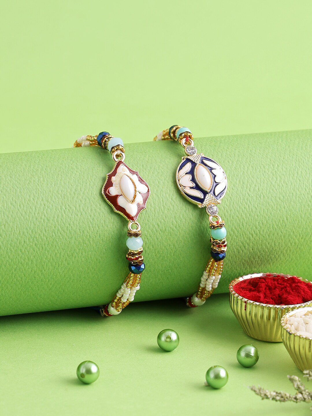 

Aapno Rajasthan Set of 2 Gold-Plated Red & Blue Meena Work Bhabhi Rakhi
