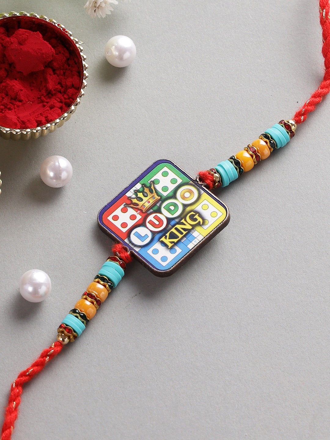 

Aapno Rajasthan Red & Blue Ludo Kids Rakhi With Roli Chawal & Raksha Bandhan Greeting Card