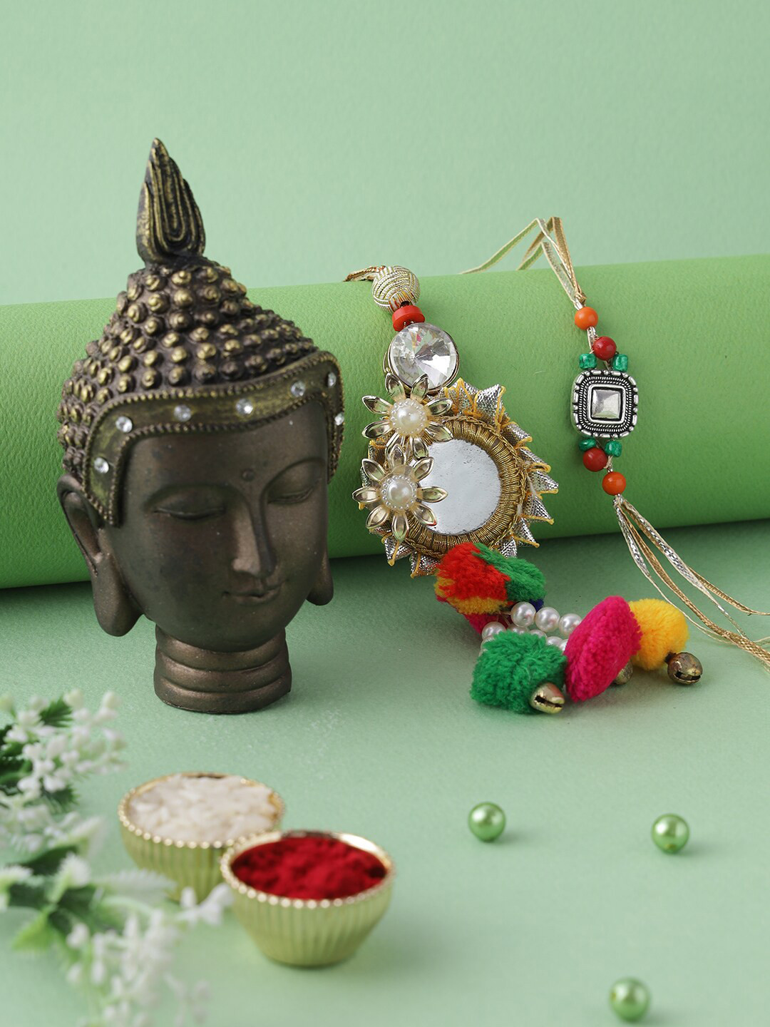 

Aapno Rajasthan Multicoloured Buddha Resin Art with Bhaiya Bhabhi Rakhi Gift Set, Gold